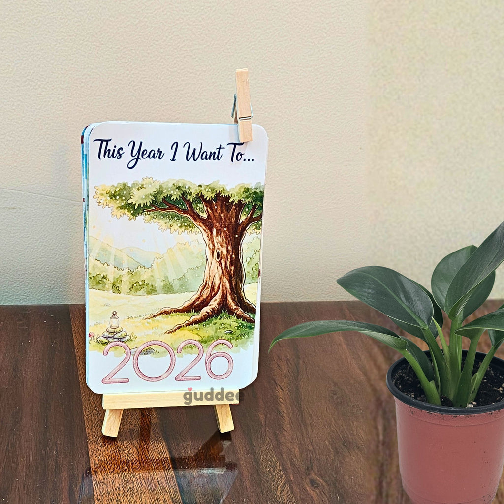 Positive affirmations desk calendar 2026 open to a monthly page on a clean modern office workspace.
