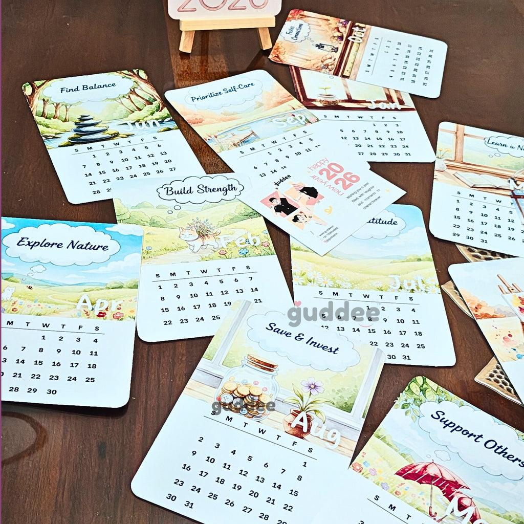 A styled office desk featuring the 2026 positive affirmations calendar next to a laptop and notebook