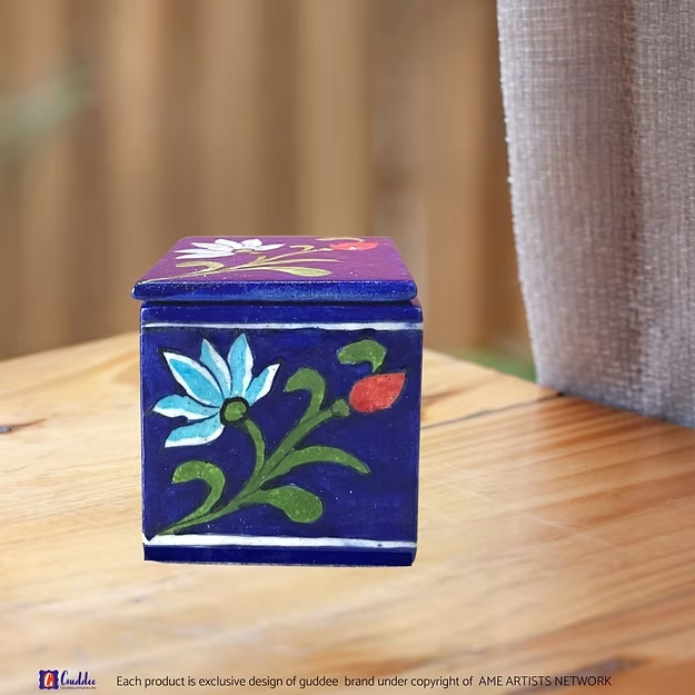Close-up of the smooth glass-glazed surface and intricate blue floral brush patterns on an authentic clay-free quartz box.