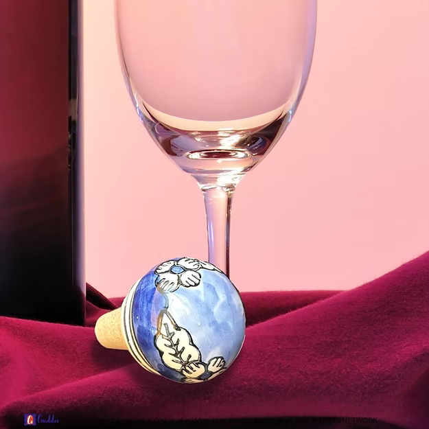 Blue Lagoon wine cork showing the vibrant hand-painted blue pottery circular floral details by Guddee.