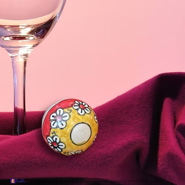 Red Yellow Drama wine cork showing the vibrant hand-painted blue pottery circular geometric details by Guddee.