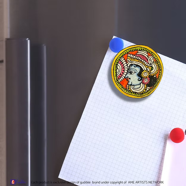 An authentic Krishna faux leather magnet holding a reminder note on a modern steel kitchen refrigerator door panel.