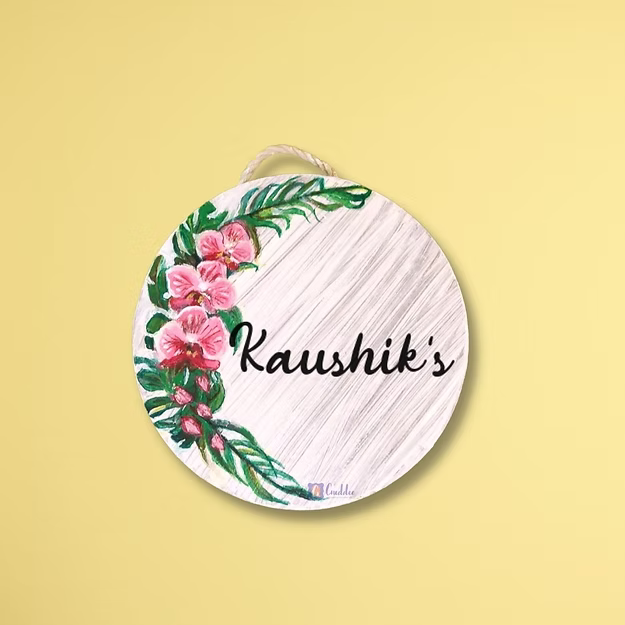An elegant personalized orchid house name plate presented beautifully as a premium housewarming gift for new homeowners.