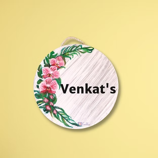 An elegant personalized orchid house name plate presented beautifully as a premium housewarming gift for new homeowners.