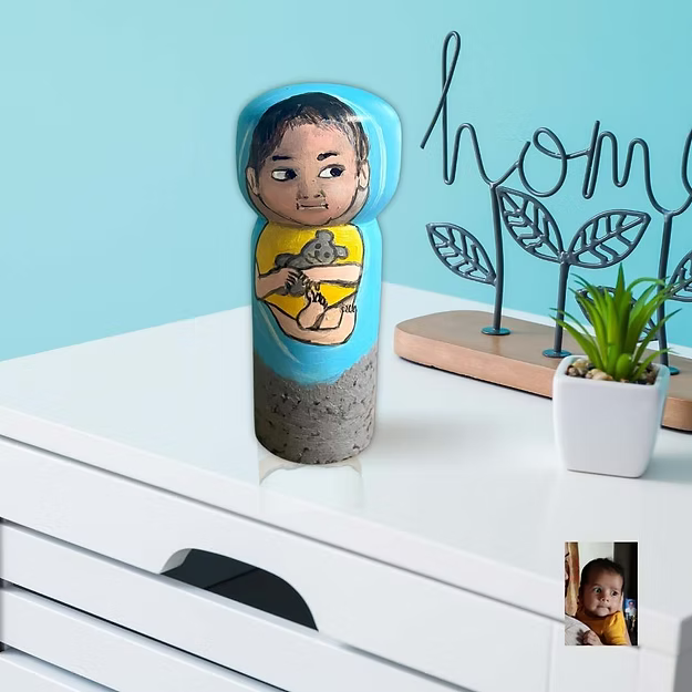 Baby personalized wooden hand painted wood doll showing the custom infant clothes and photo-matched details by Guddee.