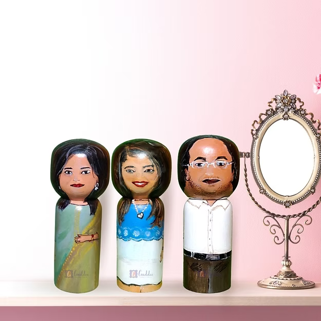 A custom 3-pack personalized wooden family doll set displayed beautifully as minimalist nursery shelf home decor.