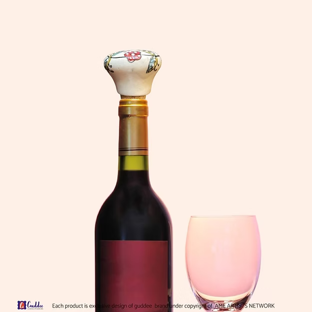 White Garden wine cork showing the vibrant hand-painted blue pottery circular floral details by Guddee.