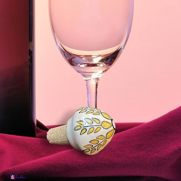 White wine cork showing the vibrant hand-painted blue pottery circular floral details by Guddee.