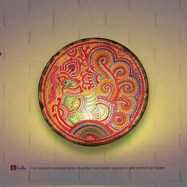 A lit translucent Tholu Bommalata leather peacock sconce projecting a glowing, multi-colored folk pattern on a hallway wall.