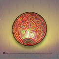 A lit translucent Tholu Bommalata leather peacock sconce projecting a glowing, multi-colored folk pattern on a hallway wall.