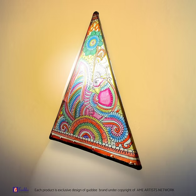 A lit triangular synthetic leather peacock silhouette lamp casting a warm ambient glow as a decorative table centerpiece.