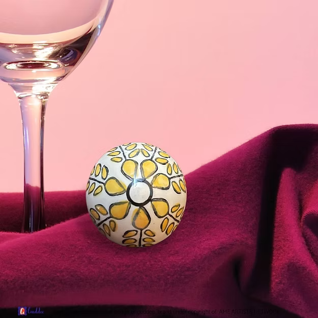 White yellow wine cork showing the vibrant hand-painted blue pottery circular geometric details by Guddee.