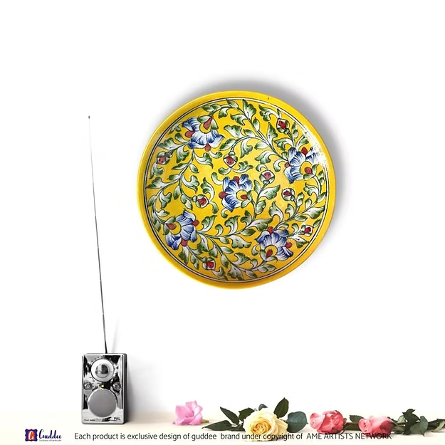 A handcrafted 10-inch floral hues yellow pottery wall plate hanging as an elegant focal point in a modern living room.