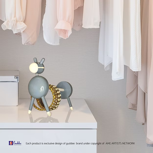 A tissue dispensing smoothly from a grey donkey holder with paperclips and keys resting inside its built-in vanity valet tray.