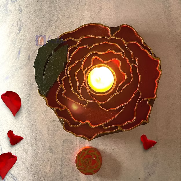 A lit rosewood floral tea light holder sitting as a warm decorative centerpiece table runner accent on a wooden table.