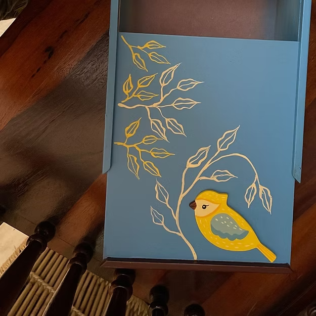 A large handcrafted wooden birdie box sliding open smoothly to reveal watches and fine valuables on a premium vanity table.