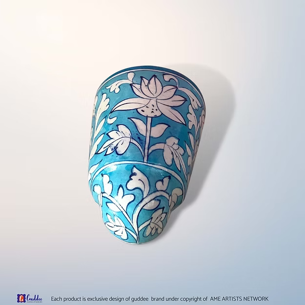 Aasmani blue blue pottery wall planter pot showing the vibrant sky-blue hand-painted floral motifs by Guddee.