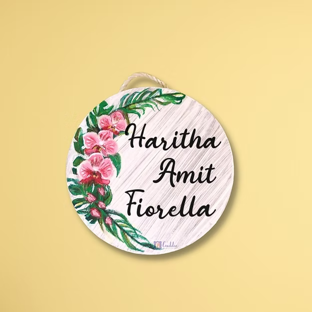 An elegant personalized orchid house name plate presented beautifully as a premium housewarming gift for new homeowners.