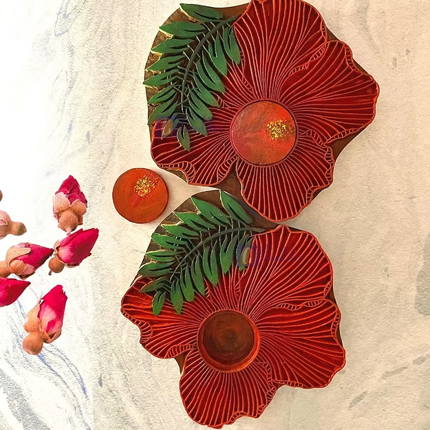 Hibiscus sheesham wood wall candle sconce by Guddee featuring elegant hand-carved floral tea light accents.