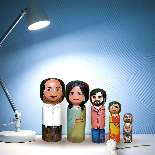 Five custom wooden peg dolls of varying heights hand-painted by regional artisans to match a 5-member family portrait.