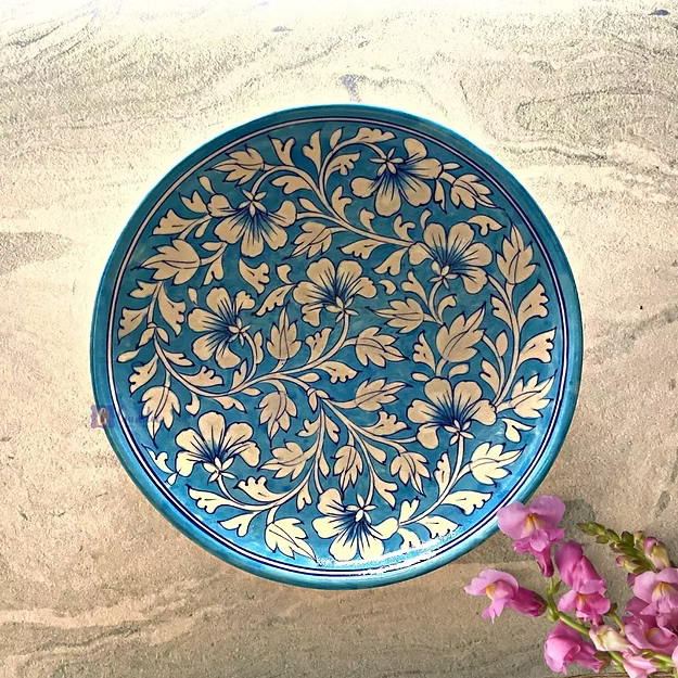 Light blue handcrafted Jaipur blue pottery wall plate featuring traditional hand-painted floral art mounted as home decor.