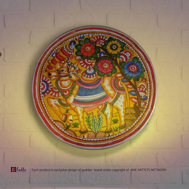 A lit translucent Tholu Bommalata leather Nandi sconce projecting a glowing, multi-colored folk pattern on a hallway wall.