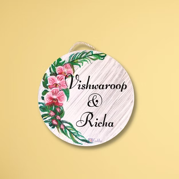 Personalised orchid floral name plate featuring a custom family name mounted next to a modern home entrance door.