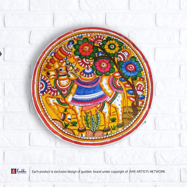 Circle Nandi faux leather Tholu Bommalata wall decor tea light holder showing the rich hand-painted details by Guddee.