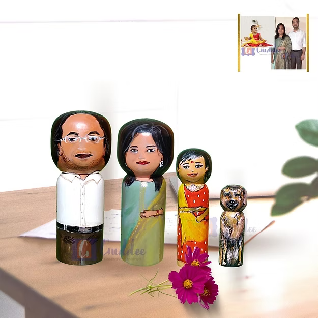 Four custom wooden peg dolls of varying heights hand-painted by regional artisans to match a 4-member family portrait.