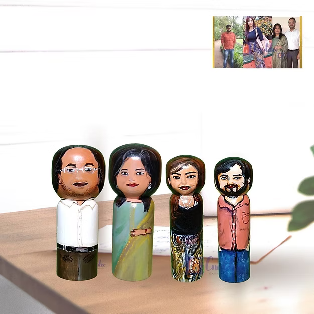 Set of 4 personalized wood dolls hand-painted to look like a family of four from a custom family portrait photo.