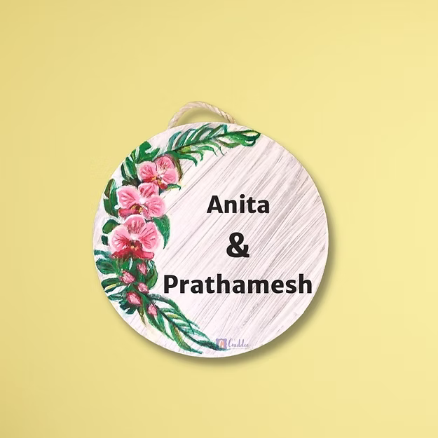 An elegant personalized orchid house name plate presented beautifully as a premium housewarming gift for new homeowners.