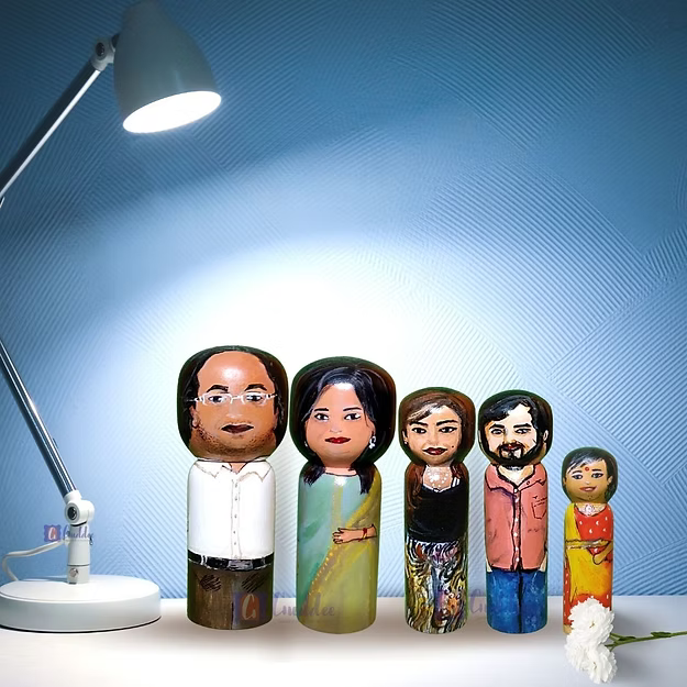 Set of 5 personalized wood dolls hand-painted to look like a family of five from a custom family portrait photo.