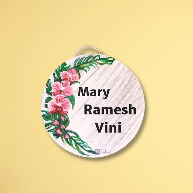 An elegant personalized orchid house name plate presented beautifully as a premium housewarming gift for new homeowners.