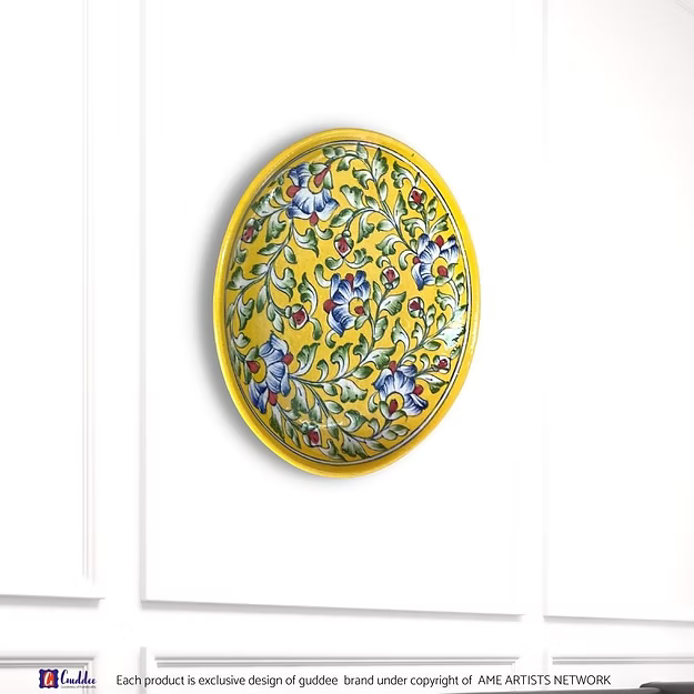 A handcrafted 10-inch floral hues yellow pottery wall plate hanging as an elegant focal point in a modern living room.
