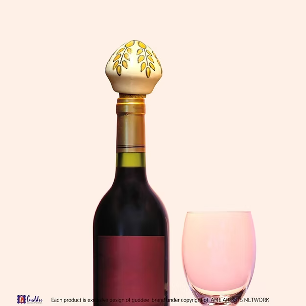 Yellow Sunshine wine cork showing the vibrant hand-painted blue pottery circular floral details by Guddee.