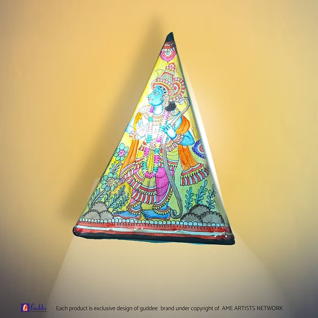 A lit triangular synthetic leather Ram Sita silhouette lamp casting a warm ambient glow as a decorative prayer room centerpiece.