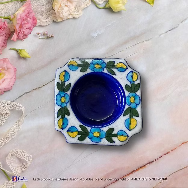 Close-up of the traditional hand-painted floral motifs on an authentic quartz ceramic blue pottery mini tea light stand.