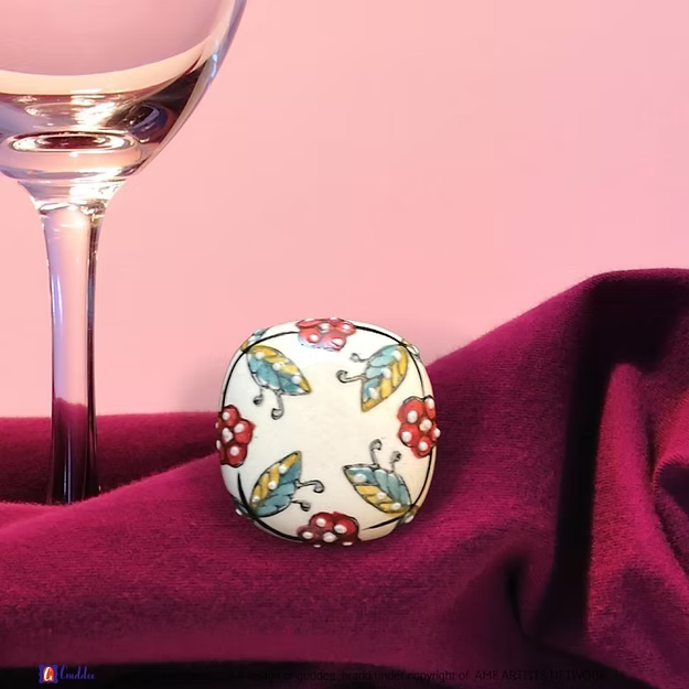 White Garden wine cork showing the vibrant hand-painted blue pottery circular floral details by Guddee.