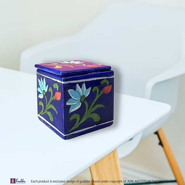 Close-up of the smooth glass-glazed surface and intricate blue floral brush patterns on an authentic clay-free quartz box.