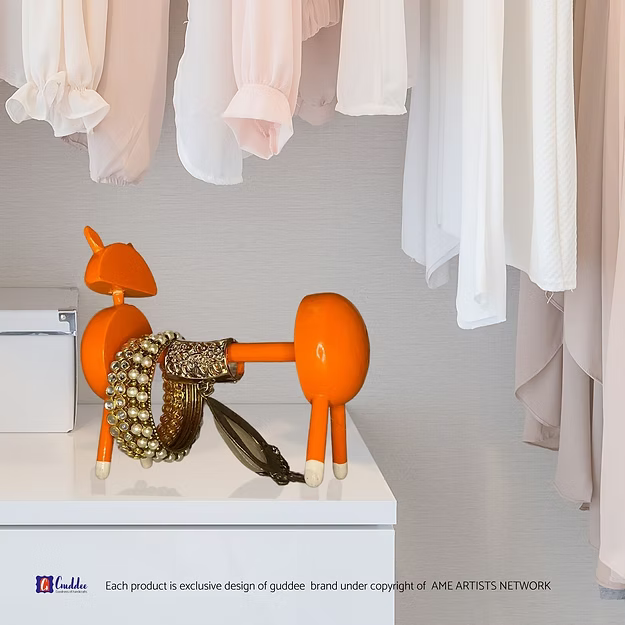 A tissue dispensing smoothly from an orange cat holder with rings and keys resting inside its built-in vanity valet tray.