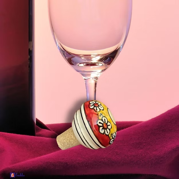 Red Yellow Drama wine cork showing the vibrant hand-painted blue pottery circular geometric details by Guddee.