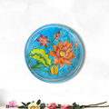 A handcrafted 8-inch blue lotus blossom pottery wall plate hanging as an elegant focal point in a modern living room.