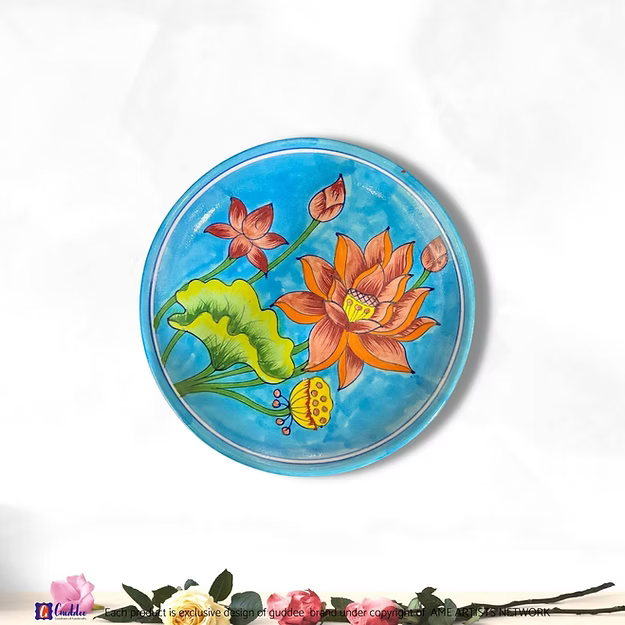 A handcrafted 8-inch blue lotus blossom pottery wall plate hanging as an elegant focal point in a modern living room.