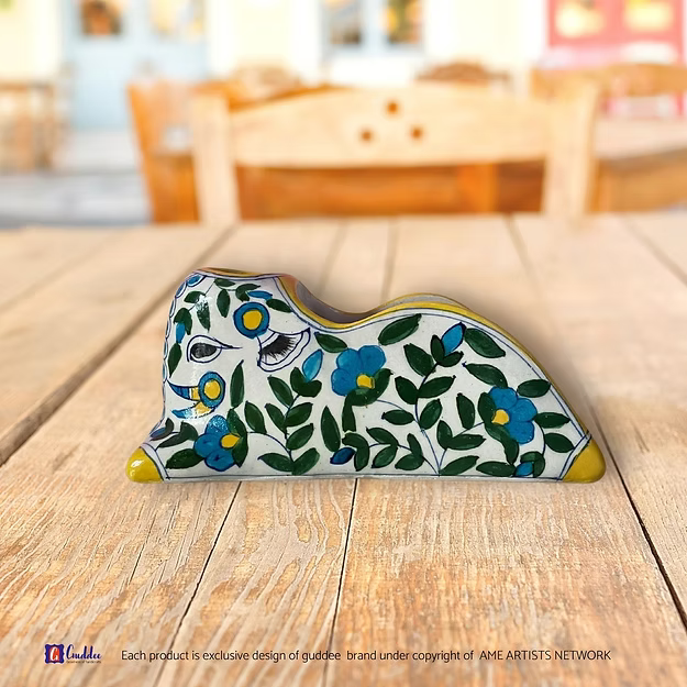 Close-up of the high-gloss glazed finish and intricate fun bright blue flower brushstrokes on an authentic quartz pottery stand.