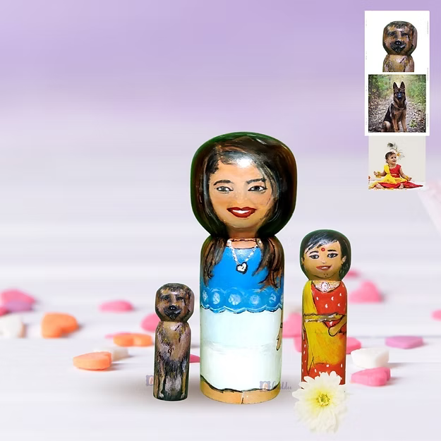 Three custom wooden peg dolls of varying heights hand-painted by regional artisans to match a 3-member family portrait.