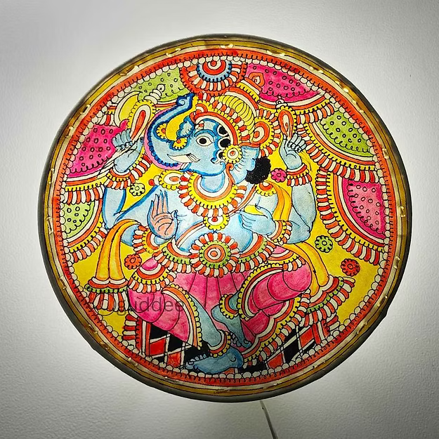 A lit synthetic leather Ganesha silhouette electric bulb lamp casting a powerful devotional shadow profile across a pooja room wall.