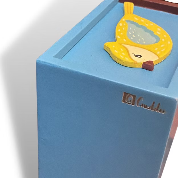 Close-up of the fluid mechanical slider lid track and the vibrant glossy finish on Guddee's small bird storage chest.