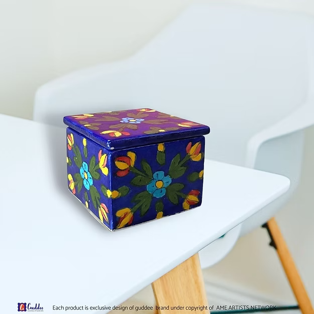 Close-up of the smooth glass-glazed surface and intricate floral blossom brush patterns on an authentic clay-free quartz box.