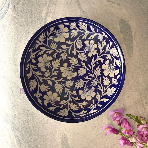 dark blue handcrafted Jaipur blue pottery wall plate featuring traditional hand-painted floral art mounted as home decor.