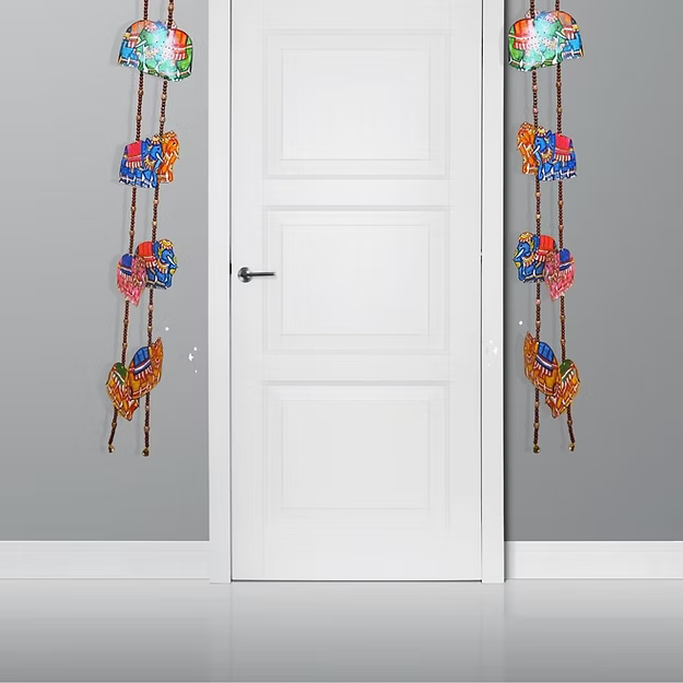 Symmetrical vertical synthetic leather elephant hanging panels styled beautifully on either side of a traditional home entryway.